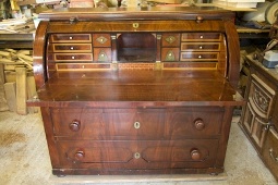 A mahogany roll top bureau before restoration